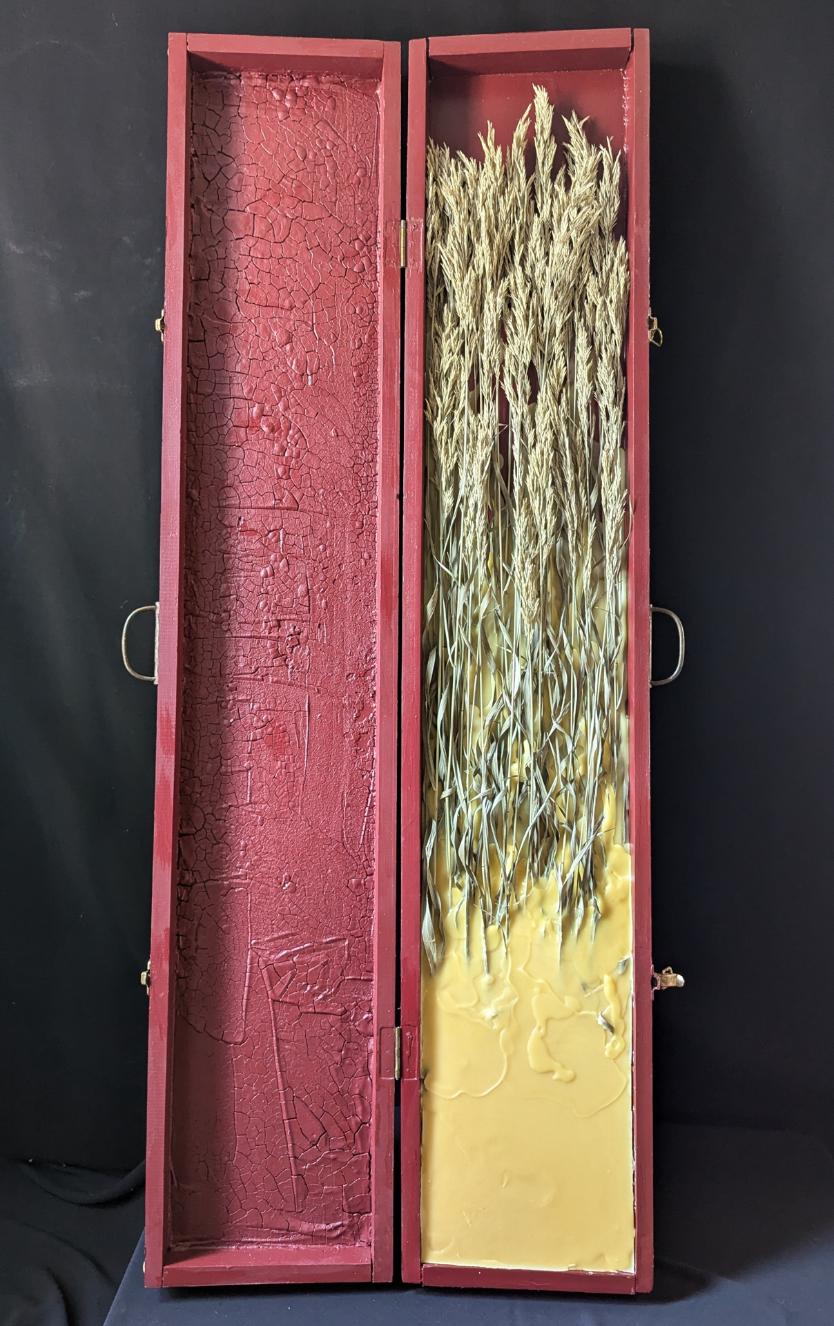 Susan Heggestad, Vermillion, SD, USA. “a nation with more guns than people,” wooden rifle box, preserved grasses, beeswax, clay, and acrylic paint.