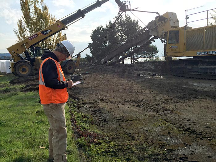 Justin Dauphinais overseeing a groundwater barrier install on Willamette River in Portland, Oregon.